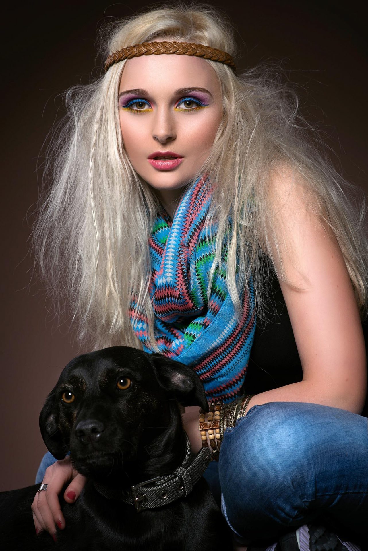 Colourful fashion portrait with a black dog