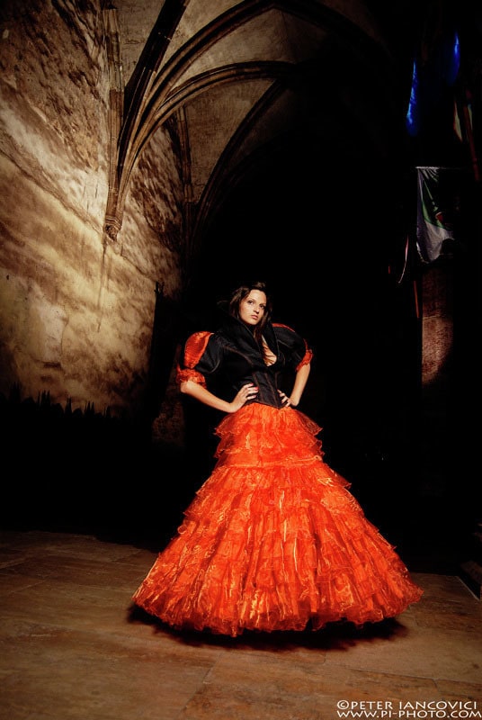 Fashion portrait featuring a dramatic red gown
