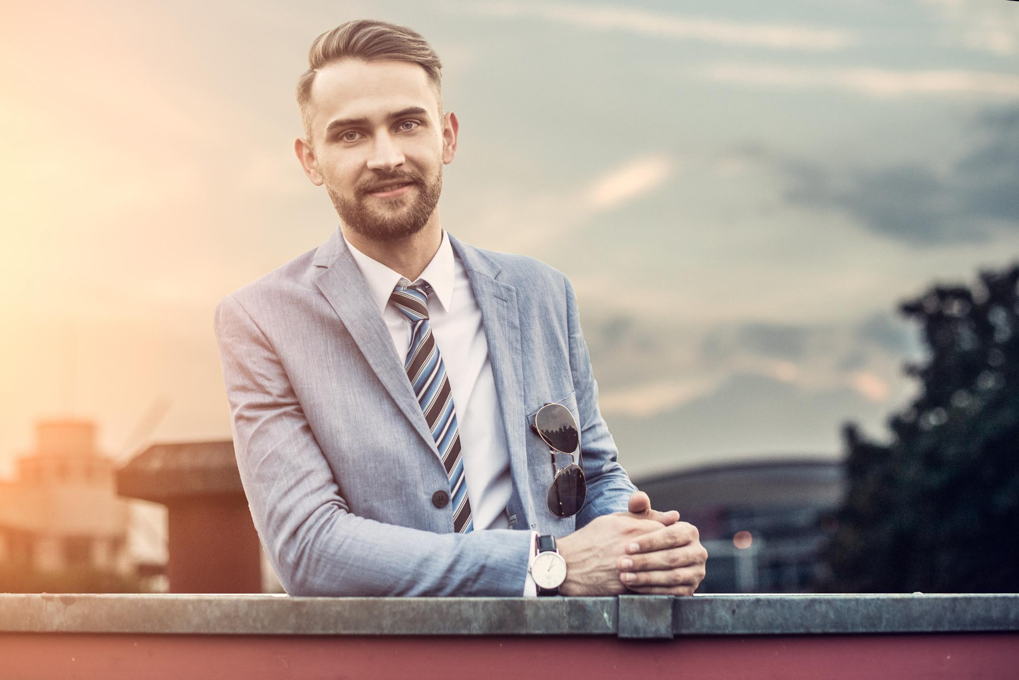 Portrait of a man in a light suit at sunset