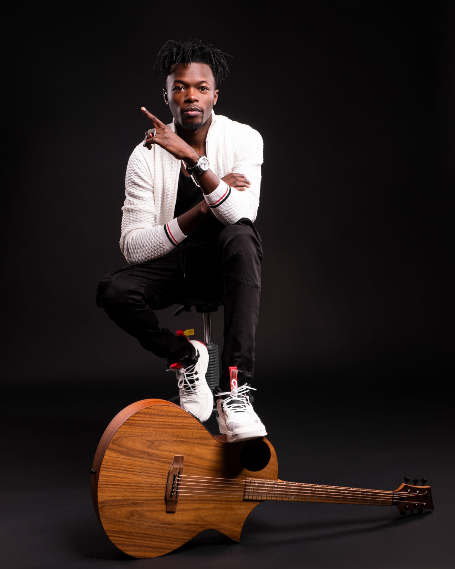 Menswear portrait of a musician with a guitar