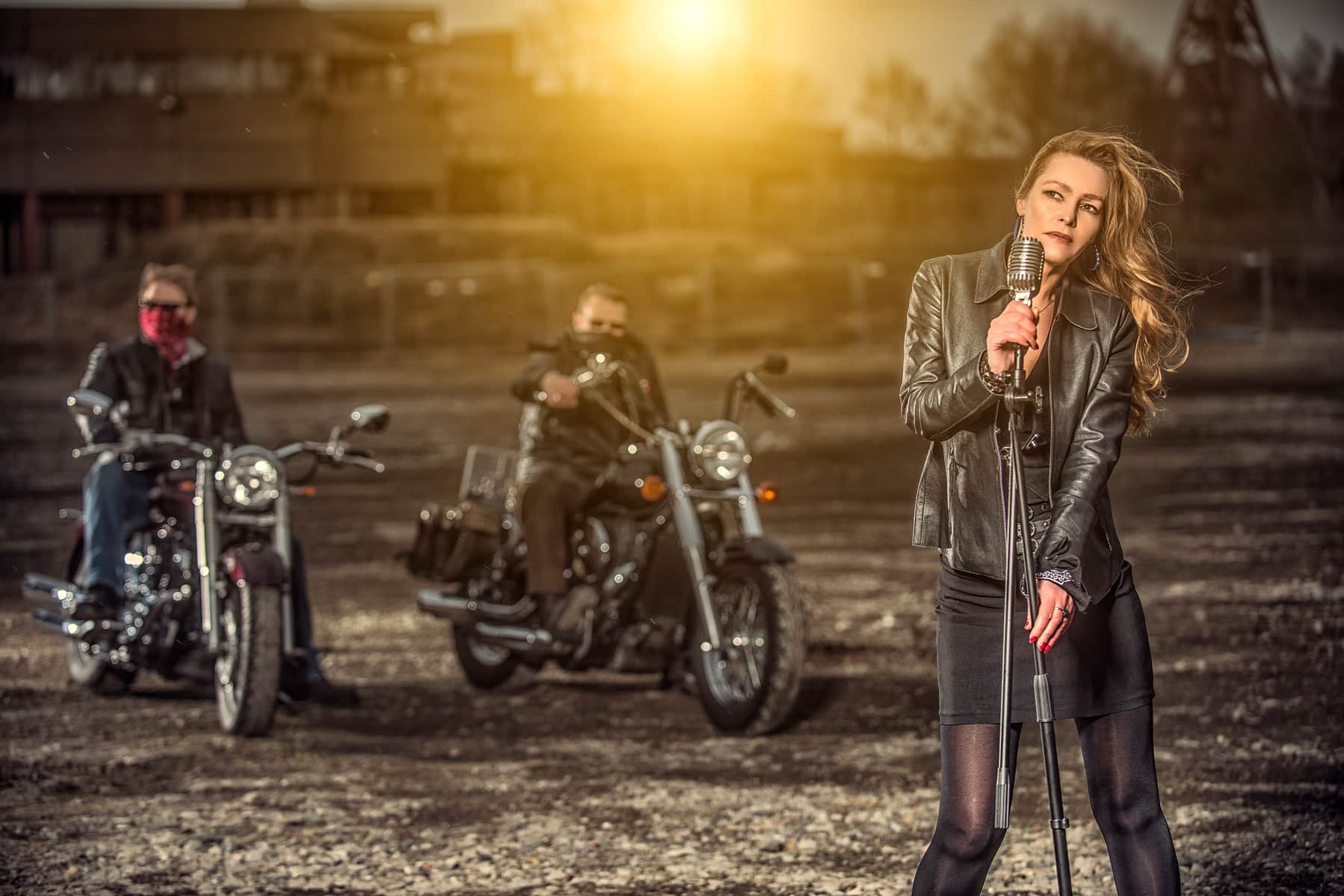 Singer performing in front of motorcycles